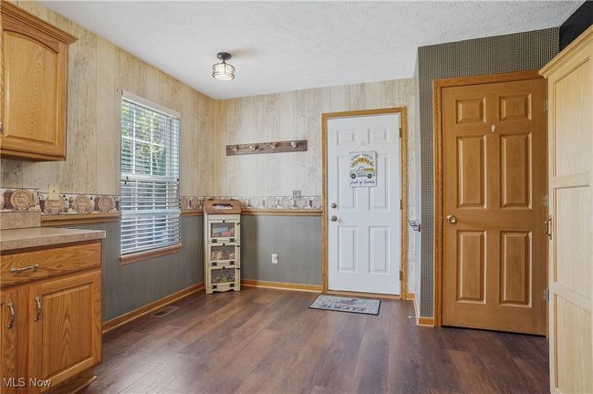 Entryway with dark wood-style flooring, visible vents, a textured ceiling, and baseboards | Image 13