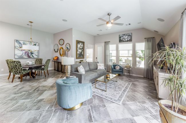 Imagine an inviting open-concept living area seamlessly flowing into a cozy breakfast nook, designed to maximize space and comfort. The living area is expansive, offering plenty of room for relaxation and entertainment, with natural light streaming through large windows. | Image 8