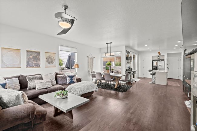 Living area with dark wood-style flooring, recessed lighting, and a textured ceiling | Image 9
