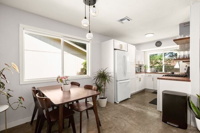 Dining room featuring concrete flooring | Image 7