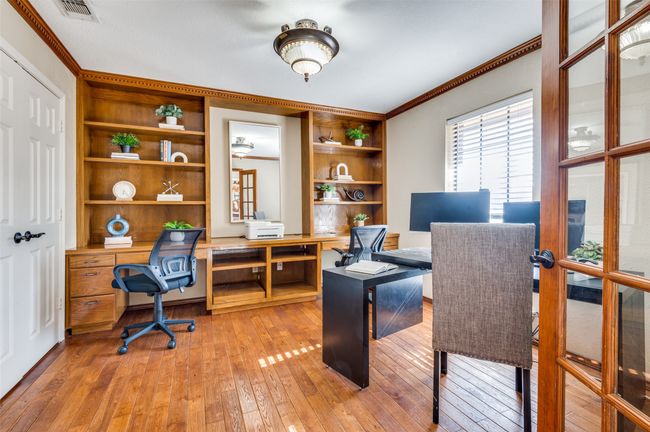 Home office with light wood-type flooring, built in features, visible vents, and crown molding | Image 6