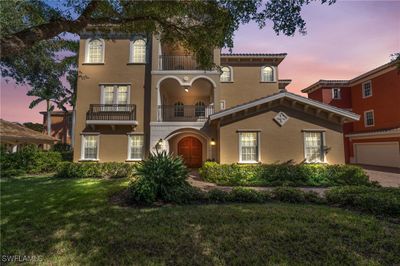 Mediterranean / spanish-style home featuring a garage, a yard, and a balcony | Image 1