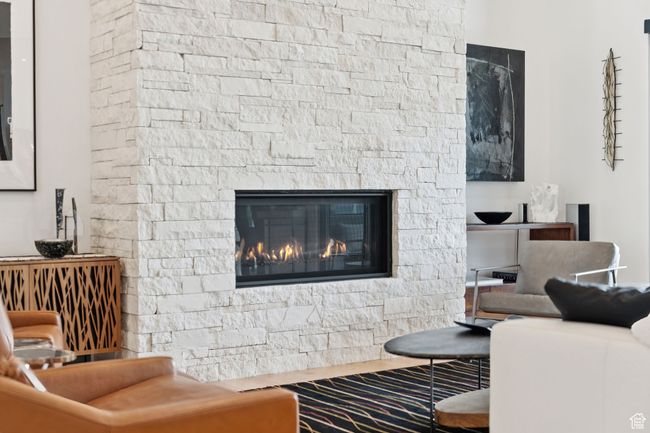 Living area with a fireplace and wood finished floors | Image 73