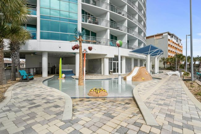 Community pool featuring a patio area and a water slide | Image 38