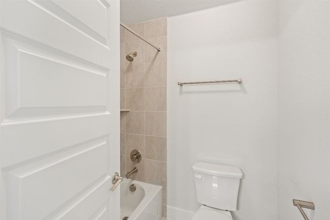 Bathroom featuring toilet and bathtub / shower combination | Image 34