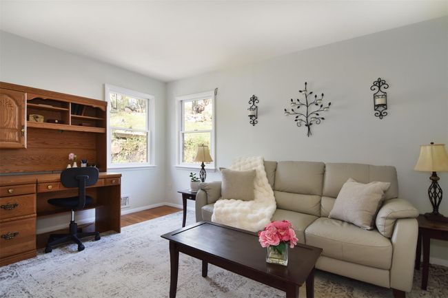 Living room featuring visible vents, light wood-type flooring, and baseboards | Image 8