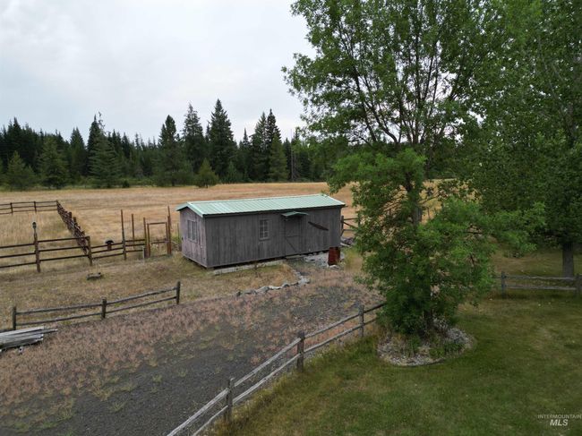 View of yard featuring a view of countryside, a storage shed, and a view of trees | Image 23