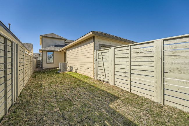 View of yard featuring a fenced backyard and central AC | Image 27