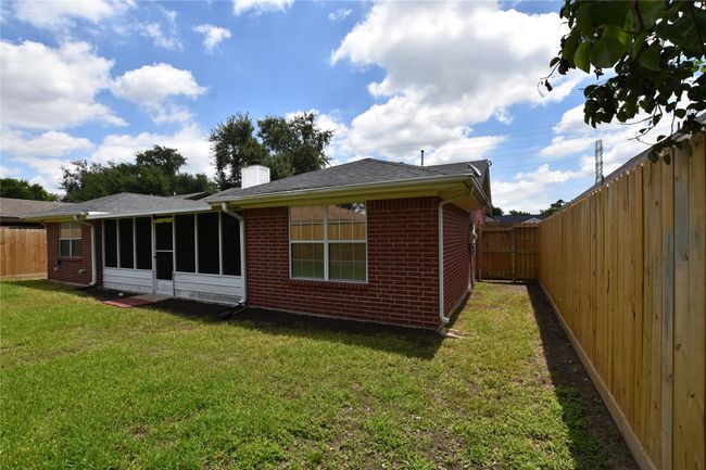 The perimeter is enclosed with a sturdy fence, ensuring privacy and security. | Image 29