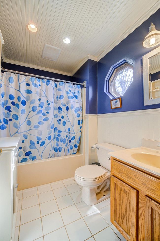 Full bath featuring a wainscoted wall, vanity, and crown molding | Image 24