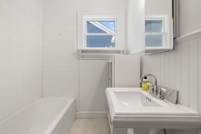 Full bathroom with a bath, tile patterned flooring, a sink, wainscoting, and walk in shower | Image 20