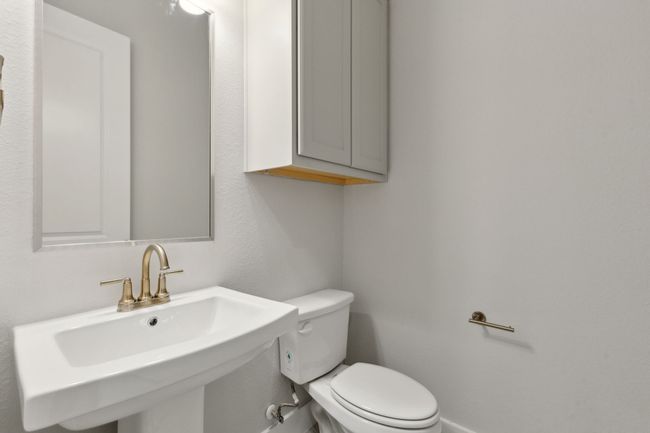 Bathroom with a sink and toilet | Image 29