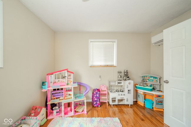 game room featuring an AC wall unit and wood finished floors | Image 22