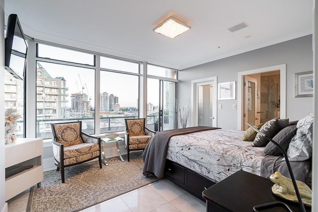Bedroom with a city view and light tile patterned flooring | Image 19