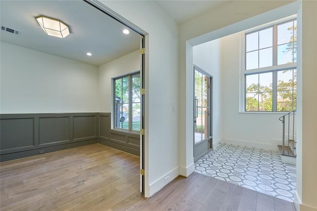 Welcome open foyer with a view of the office/study, creating a warm and elegant feel. | Image 5