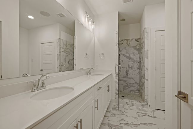 Bathroom with visible vents, marble finish floor, a stall shower, and a sink | Image 28