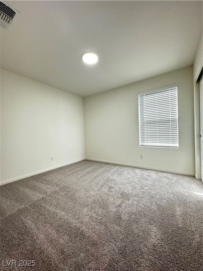 Spare room featuring carpet, visible vents, and baseboards | Image 14