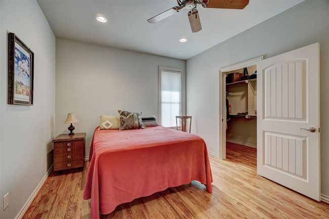 Bedroom featuring baseboards, light wood-style floors, a ceiling fan, a closet, and a walk in closet | Image 30
