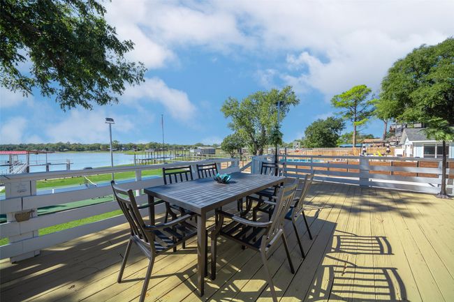Wooden terrace featuring outdoor dining space and a water view | Image 8