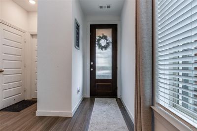 Entryway featuring plenty of natural light and dark hardwood / wood-style flooring | Image 2