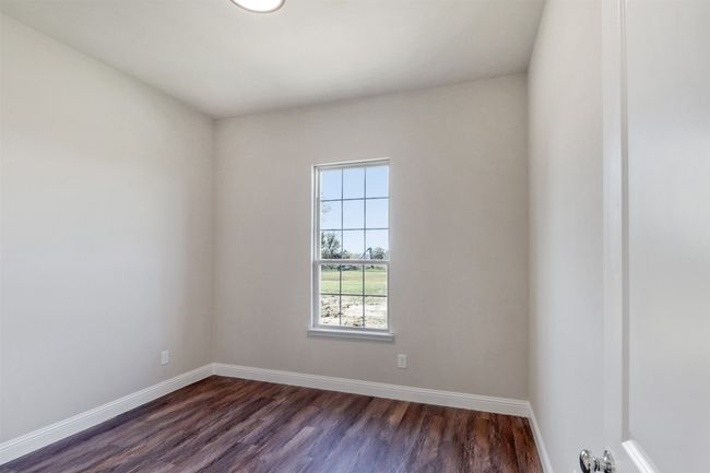 Spare room featuring dark wood-type flooring and baseboards | Image 17