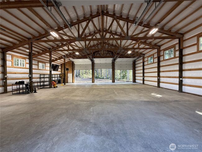 This building has the convenience of drive through 15' doors. The interior is fully insulated. The concrete floor was poured with the utmost of care. Not one crack. Also included, fiber optics, heaters, security cameras, & engineered structural plans for a loft to maximize storage or potential living quarters. | Image 5