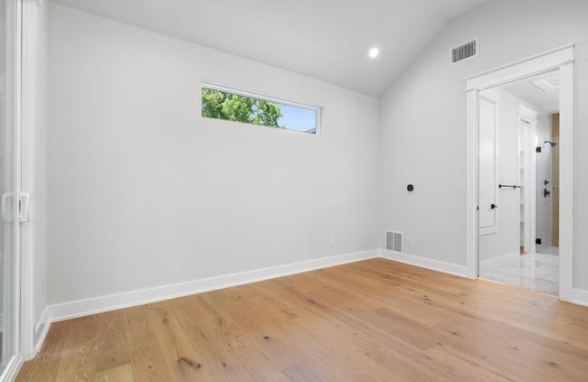 Primary Bedroom with vaulted ceiling, private balcony and tons of natural light! | Image 15