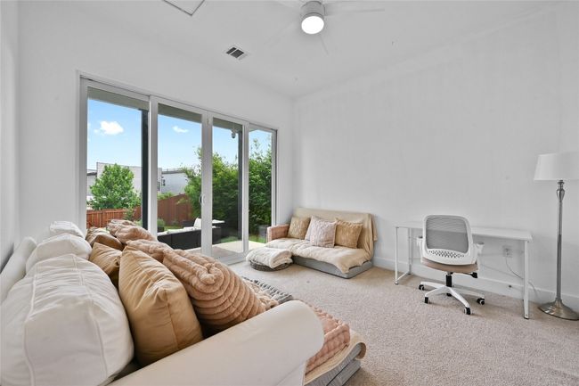 Guest bedroom on main level with sliding doors for entrance into the backyard | Image 16