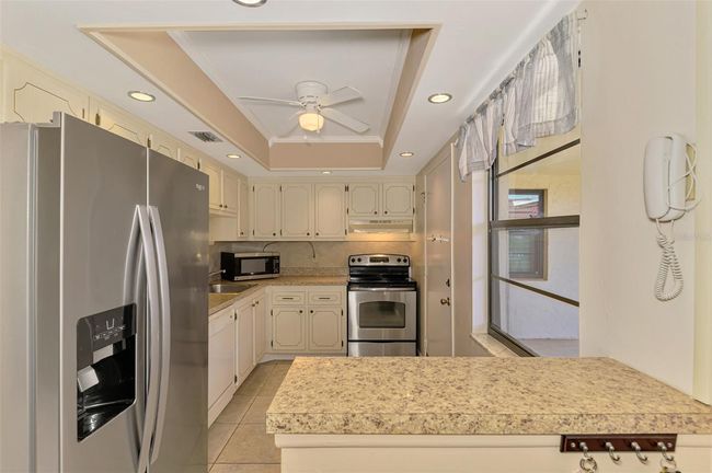 Workable, kitchen with stainless steel appliances. Ceiling fan. | Image 17