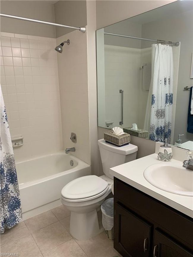 Bathroom with vanity, shower / bath combo with shower curtain, and tile patterned floors | Image 19