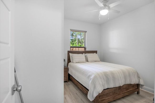 Bedroom featuring a ceiling fan, baseboards, and light wood-style floors | Image 23