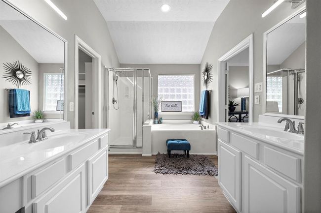 Another view of primary bathroom showing both vanity areas, separate walk-in shower and jetted tub. | Image 24