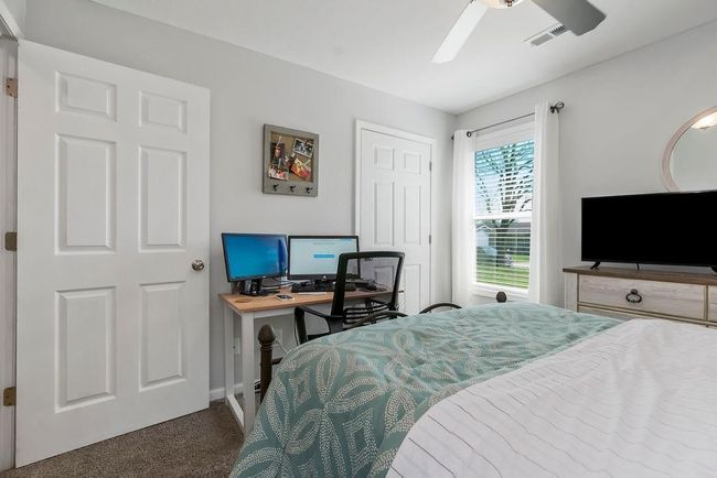Bedroom featuring visible vents, a ceiling fan, baseboards, and carpet floors | Image 22