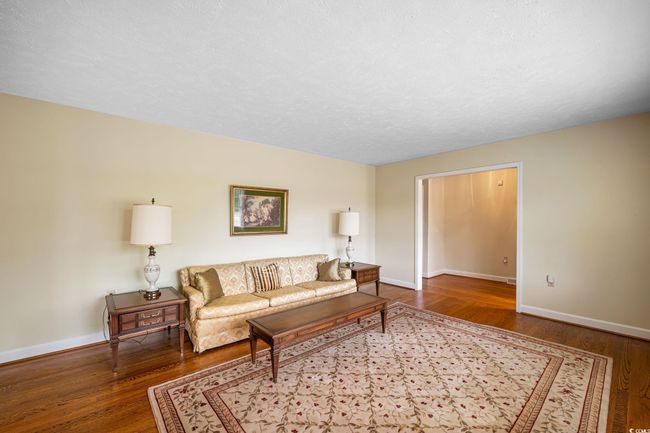 Living room with wood finished floors and baseboards | Image 27