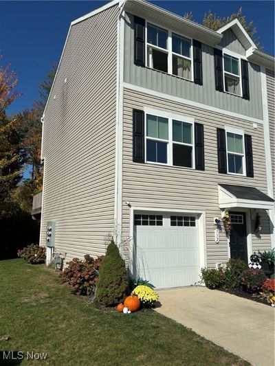 View of side of property with a yard and a garage | Image 2