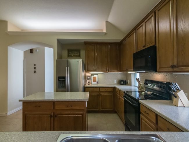 View from the breakfast bar into the kitchen. | Image 11