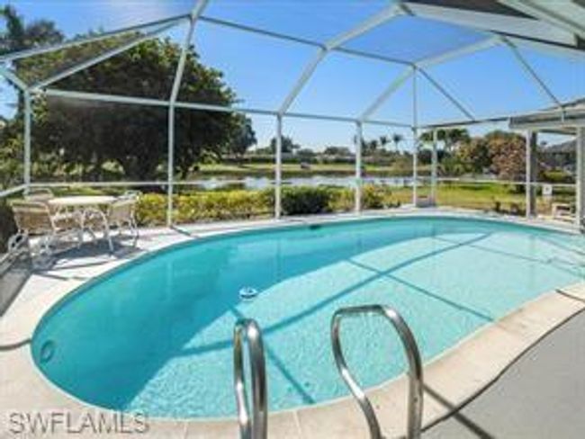 View of swimming pool featuring glass enclosure | Image 22