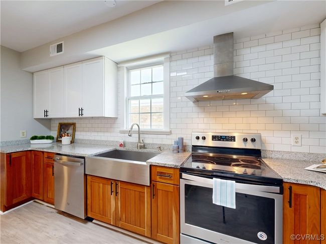 Stainless appliances, shaker upper cabinets, subway tile | Image 16