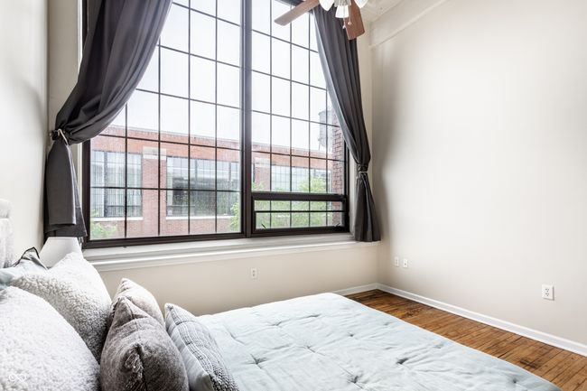 bedroom featuring multiple windows and wood finished floors | Image 20