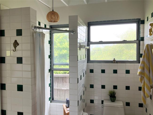Full bathroom featuring a tile shower and plenty of natural light | Image 18
