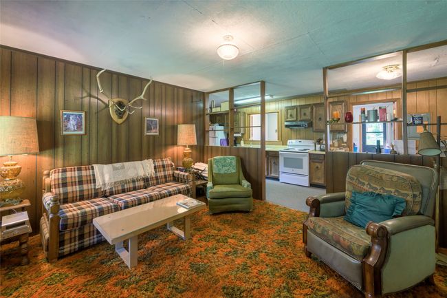 Carpeted living room with paneled walls | Image 17