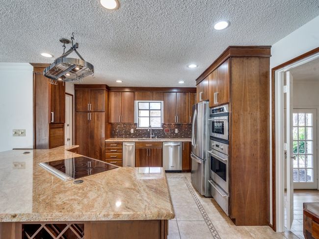 Kitchen has a huge peninsula to eat at and cook at. | Image 14