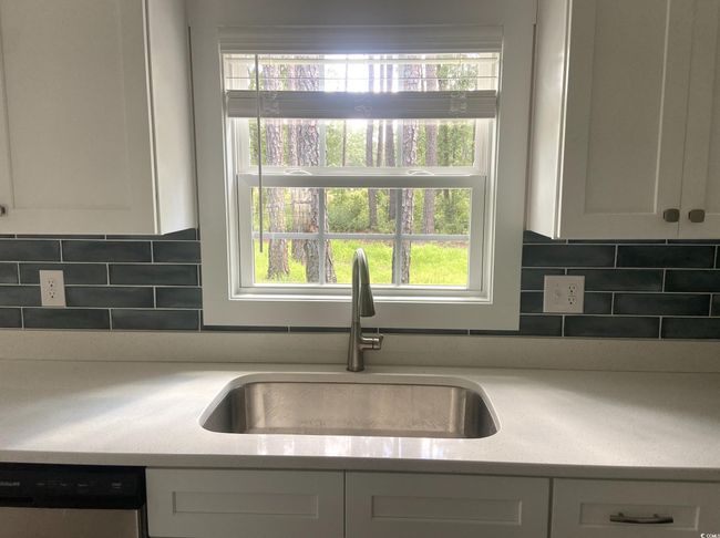 Kitchen with dishwasher, white cabinets, and plenty of natural light | Image 13
