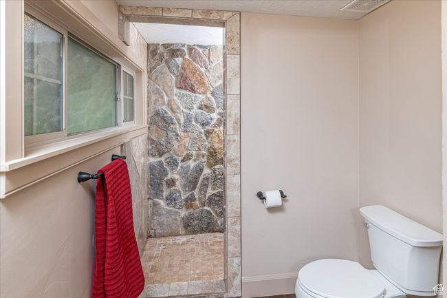 Bathroom with toilet and tiled shower | Image 31