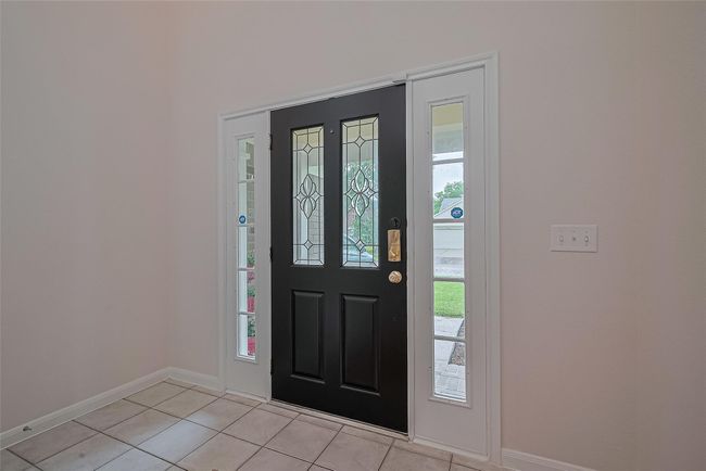 Bright and airy two-story foyer creates a stunning first impression with natural light pouring in. | Image 4