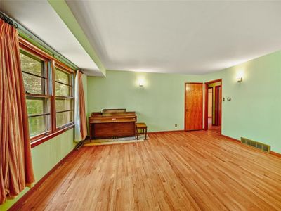 Empty room with hardwood / wood-style flooring | Image 3