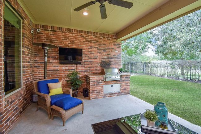 The outdoor kitchen has a built-in grill with granite counter! | Image 39