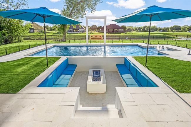Experience resort-style living in this stunning waterfront oasis, featuring a sparkling pool, sunken firepit lounge, and panoramic views. Perfectly designed for entertaining or relaxing under the sun, this backyard retreat blends luxury and tranquility in every detail. | Image 35