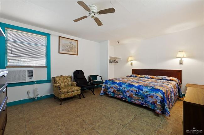 Tiled bedroom with cooling unit and a ceiling fan | Image 20