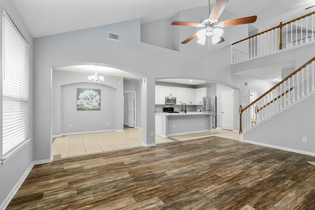 This central living area offers open sightlines across the main floor—anchored by natural light, airy ceilings, and easy flow from room to room. | Image 11